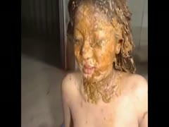 An Asian beauty smears her face with feces.